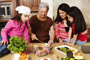 Grandmother preparing food with children